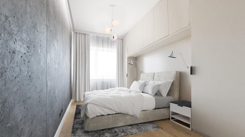 Początkowo Ola i Piotr, bohaterowie 3. odcinka "Mieszkania na miarę" planowali w sypialnię tapetę. Jednak architektka wnętrz Agnieszka Musiał namówiła ich na tynk strukturalny, który świetnie koreluje z ciepłą podłogą i jasną zabudową stolarską. Tynk to dosyć popularne rozwiązanie, jednak w tym przypadku Agnieszka pokusiła się o oryginalnym rozwiązanie - regularne fugi wprowadzające podział i urozmaicenie do tego projektu.